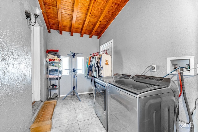 laundry room with separate washer and dryer, light tile patterned floors, and wood ceiling