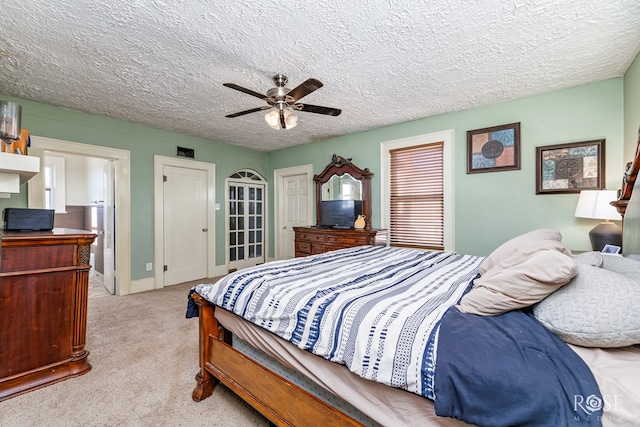 carpeted bedroom featuring a textured ceiling and ceiling fan