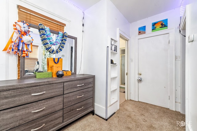 hallway with light colored carpet