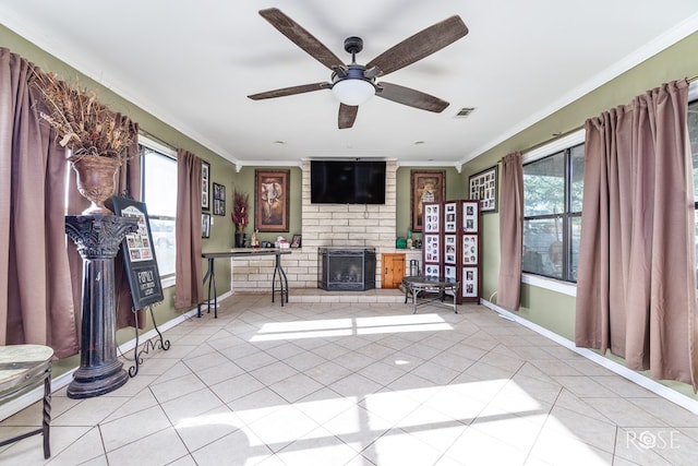 unfurnished living room featuring light tile patterned floors, a fireplace, ornamental molding, and ceiling fan