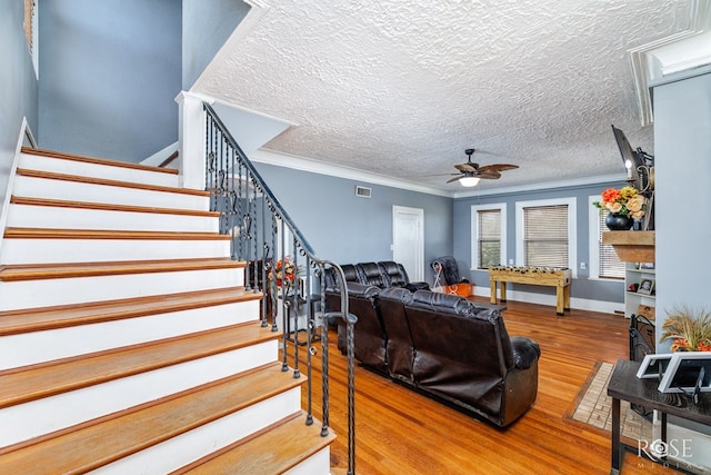 living room with crown molding, hardwood / wood-style flooring, and ceiling fan