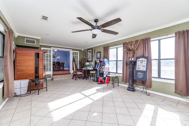 interior space featuring ornamental molding, ceiling fan, and light tile patterned flooring