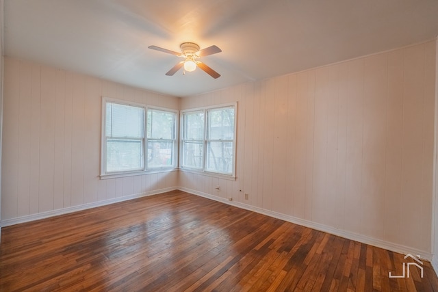 empty room featuring dark hardwood / wood-style flooring and ceiling fan