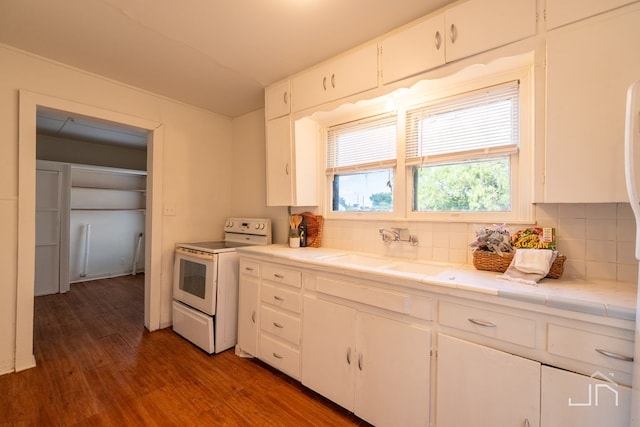 kitchen with sink, tile countertops, white cabinets, and white range with electric cooktop