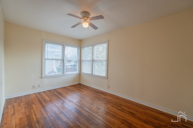 spare room with dark hardwood / wood-style floors and ceiling fan