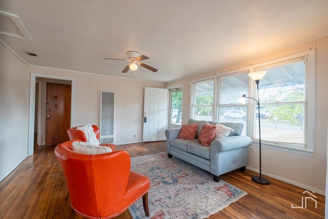 living room with dark wood-type flooring and ceiling fan