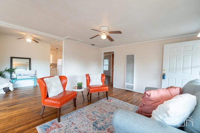 living room with crown molding, ceiling fan, and dark hardwood / wood-style floors