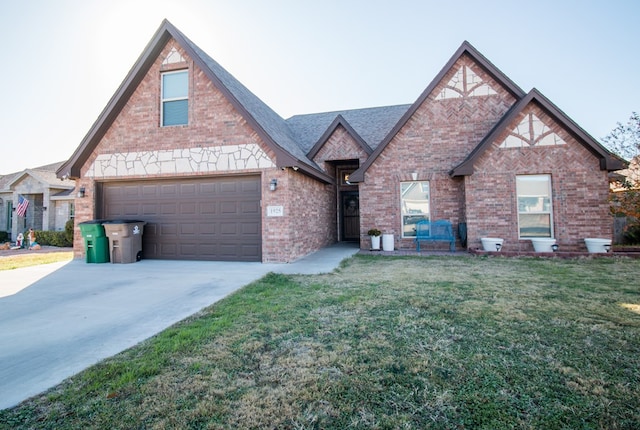 view of front of home with a garage and a front lawn