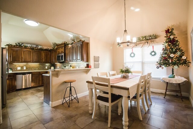 dining area with an inviting chandelier and lofted ceiling