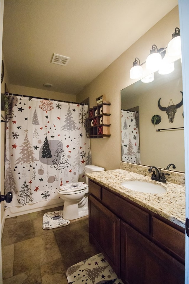 full bathroom with vanity, toilet, and shower / bath combo with shower curtain