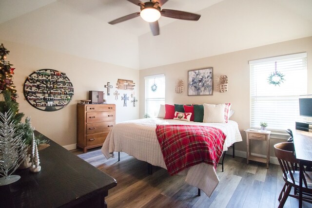 bedroom with multiple windows, hardwood / wood-style flooring, and ceiling fan