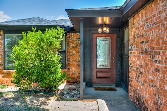 1106 Gregory Dr, San Angelo, TX 76905 - view of exterior entry featuring brick siding and roof with shingles