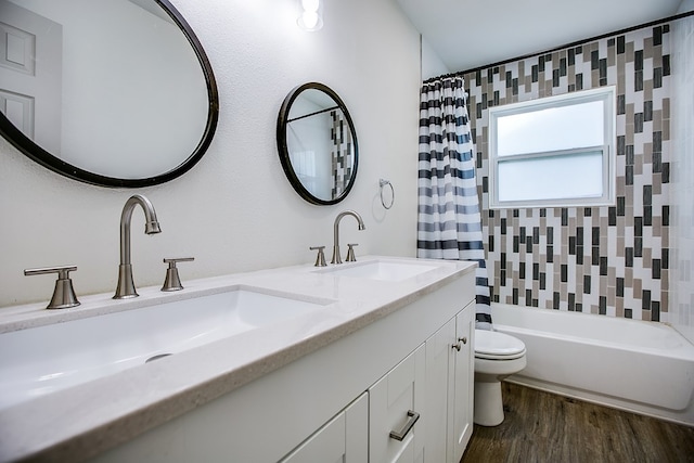 1106 Gregory Dr, San Angelo, TX 76905 - full bath featuring double vanity, wood finished floors, and shower / tub combo