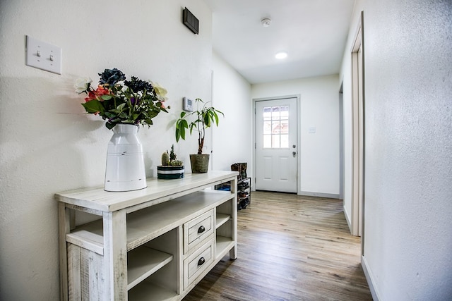 1106 Gregory Dr, San Angelo, TX 76905 - doorway to outside featuring wood finished floors and baseboards