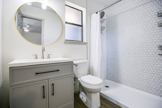 1106 Gregory Dr, San Angelo, TX 76905 - full bathroom with vanity, a tile shower, ceiling fan, and wood finished floors