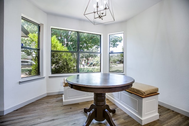 1106 Gregory Dr, San Angelo, TX 76905 - dining area featuring healthy amount of natural light, a chandelier, breakfast area, and wood finished floors