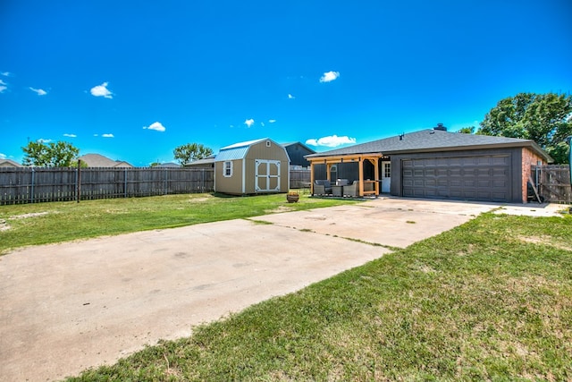 1106 Gregory Dr, San Angelo, TX 76905 - view of front of home featuring a storage unit, a fenced backyard, a garage, and concrete driveway