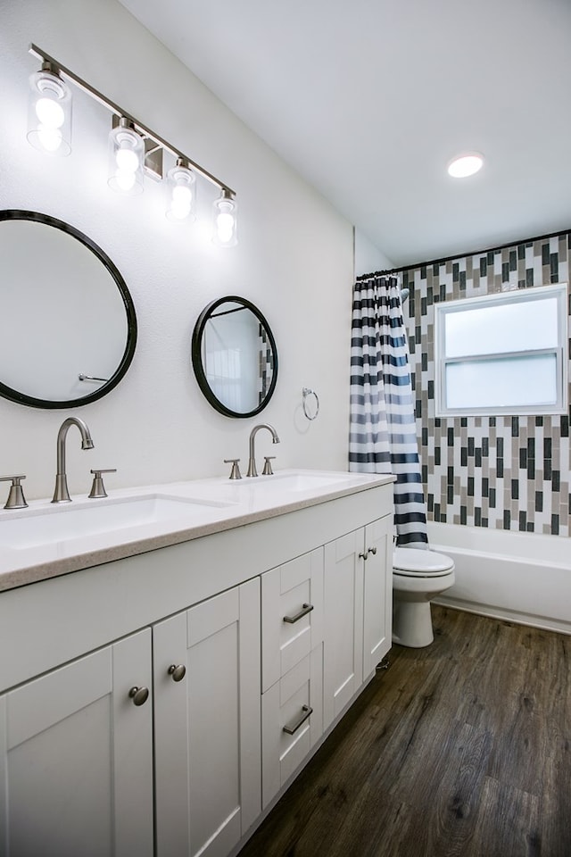 1106 Gregory Dr, San Angelo, TX 76905 - bathroom featuring double vanity, wood finished floors, and shower / bath combination with curtain