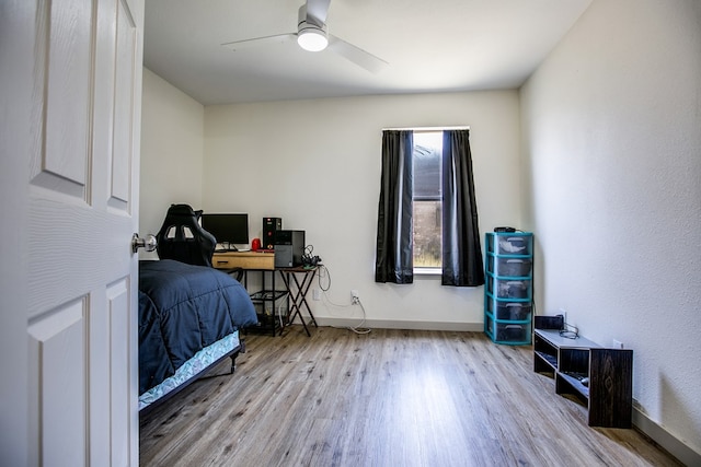 1106 Gregory Dr, San Angelo, TX 76905 - bedroom with wood finished floors, ceiling fan, and an office area