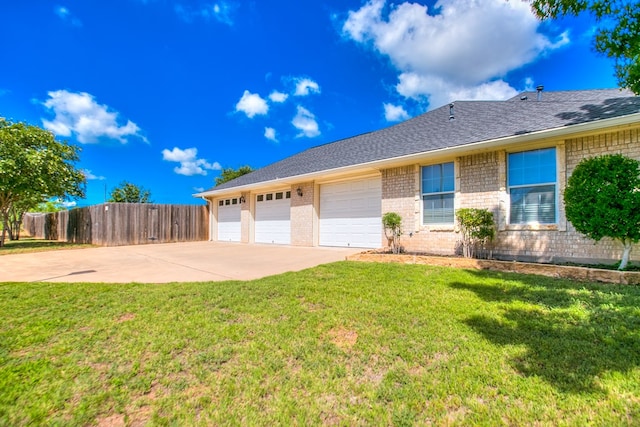 601 Burlington Rd, San Angelo, TX 76901 - view of front facade with concrete driveway, brick siding, a garage, and roof with shingles