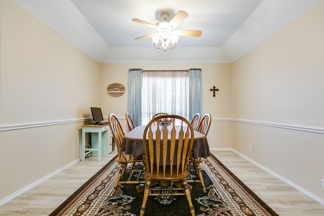 601 Burlington Rd, San Angelo, TX 76901 - dining space with light wood-style floors, a tray ceiling, a ceiling fan, and baseboards