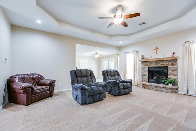 601 Burlington Rd, San Angelo, TX 76901 - carpeted living room with a ceiling fan, a tray ceiling, recessed lighting, a fireplace, and baseboards
