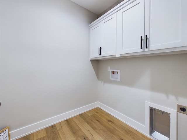 3616 Clearview Dr, San Angelo, TX 76904 - laundry room with cabinet space, electric dryer hookup, baseboards, light wood finished floors, and washer hookup