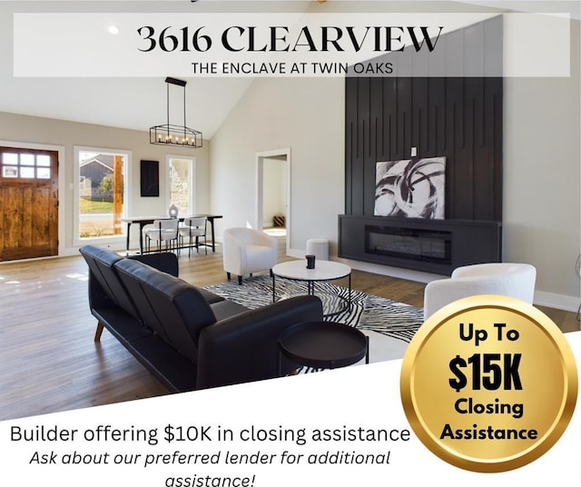 3616 Clearview Dr, San Angelo, TX 76904 - living area featuring wood finished floors, healthy amount of natural light, a chandelier, and vaulted ceiling