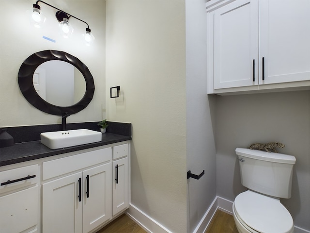 3616 Clearview Dr, San Angelo, TX 76904 - half bath featuring wood finished floors, vanity, toilet, and baseboards