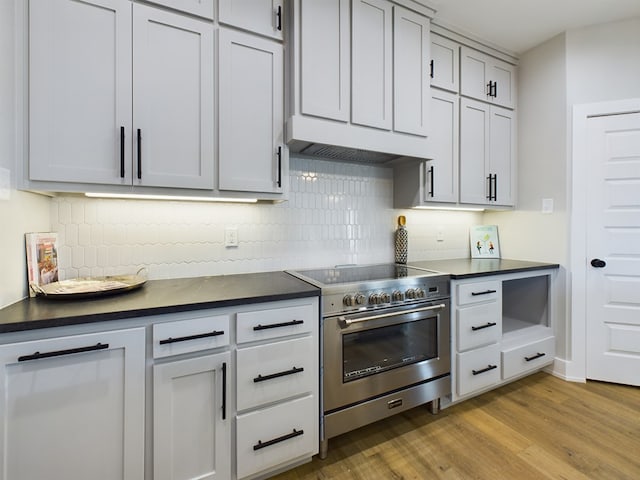 3616 Clearview Dr, San Angelo, TX 76904 - kitchen featuring high end stove, dark countertops, and decorative backsplash