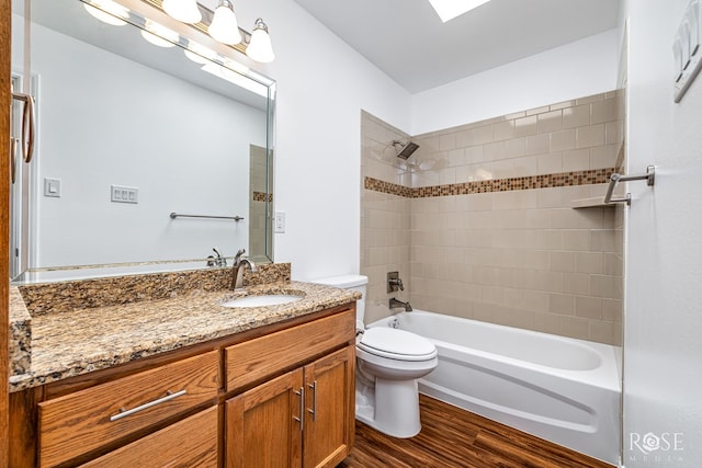 4129 Sedona Trl, San Angelo, TX 76904 - bathroom with vanity, toilet, wood finished floors, and bathing tub / shower combination
