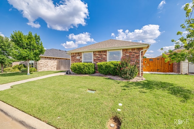 4129 Sedona Trl, San Angelo, TX 76904 - view of front of house with a shingled roof, brick siding, and a gate