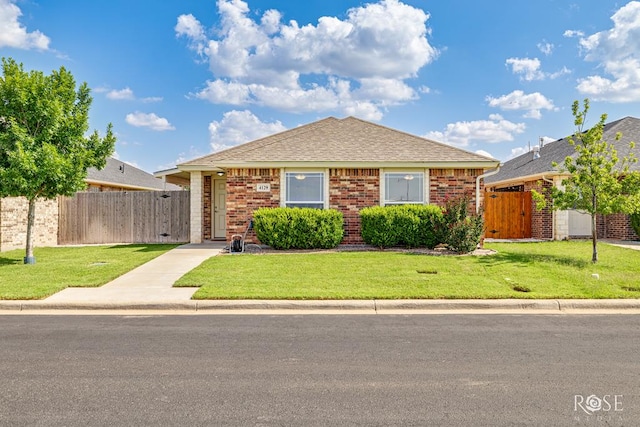 4129 Sedona Trl, San Angelo, TX 76904 - view of front of house with a gate, brick siding, and a shingled roof