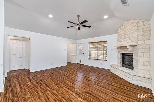 4129 Sedona Trl, San Angelo, TX 76904 - unfurnished living room featuring wood finished floors, ceiling fan, vaulted ceiling, baseboards, and a stone fireplace