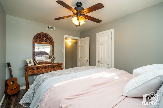 bedroom with ceiling fan and dark hardwood / wood-style floors