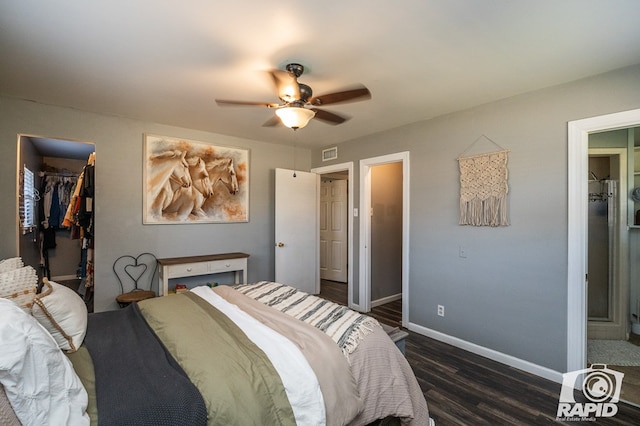 bedroom featuring dark hardwood / wood-style flooring, a spacious closet, a closet, and ceiling fan