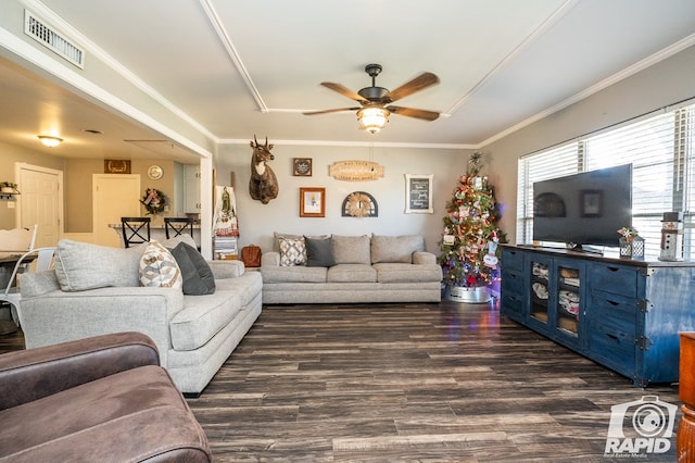 living room with dark hardwood / wood-style flooring, ornamental molding, and ceiling fan