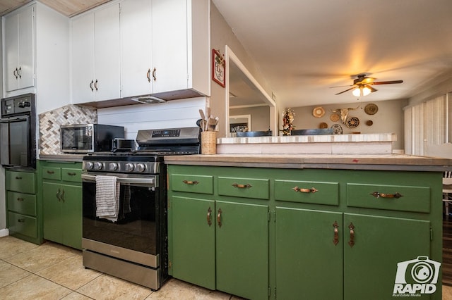 kitchen with green cabinets, stainless steel appliances, ceiling fan, and light tile patterned flooring