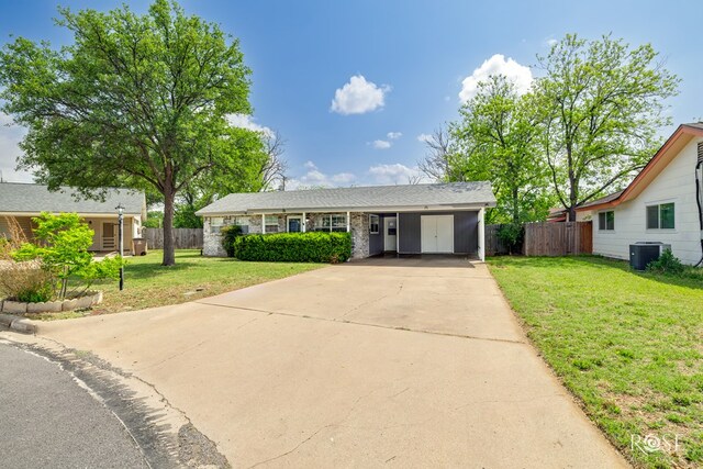 3109 College Hills Cir, San Angelo, TX 76904 - view of front of home featuring concrete driveway, central air condition unit, stone siding, and an attached carport