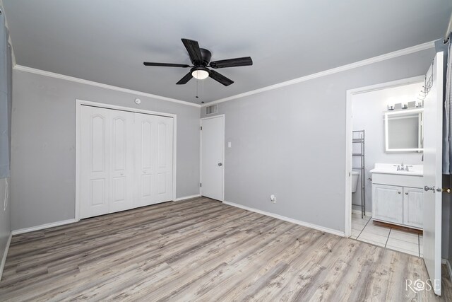 3109 College Hills Cir, San Angelo, TX 76904 - unfurnished bedroom featuring light wood-type flooring, a closet, ornamental molding, baseboards, and connected bathroom