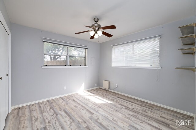 3109 College Hills Cir, San Angelo, TX 76904 - unfurnished bedroom featuring wood finished floors, a closet, baseboards, and ceiling fan