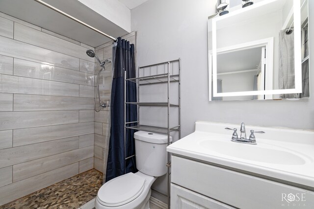 3109 College Hills Cir, San Angelo, TX 76904 - bathroom with toilet, vanity, and tiled shower
