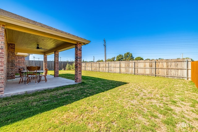 view of yard featuring a patio and ceiling fan