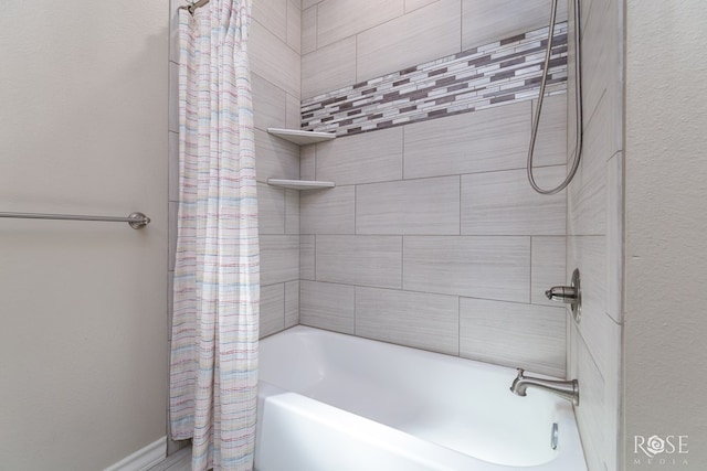 bathroom with shower / bath combo with shower curtain