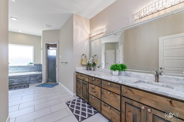 bathroom with vanity and separate shower and tub