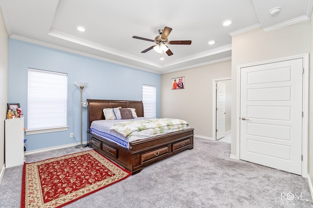 carpeted bedroom with ornamental molding, a raised ceiling, and ceiling fan