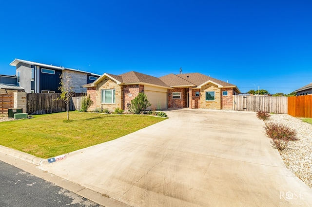 single story home featuring a garage and a front lawn