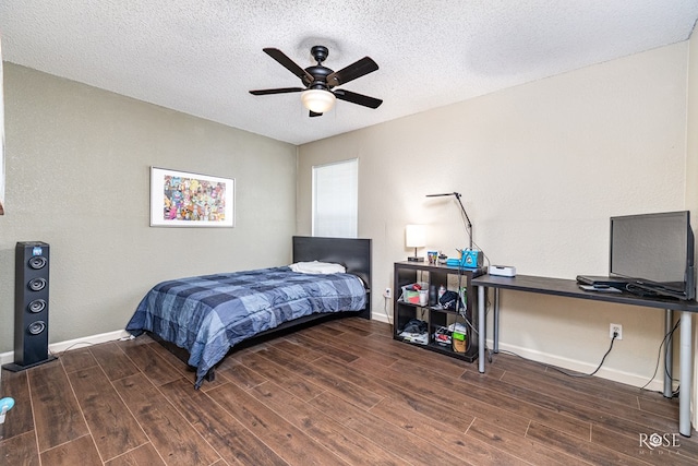 705 Fay St, Sonora, TX 76950 - bedroom with wood finished floors, an office area, a textured ceiling, and a ceiling fan