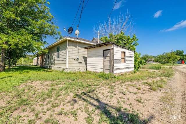 705 Fay St, Sonora, TX 76950 - view of home's exterior with an outbuilding