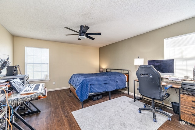 705 Fay St, Sonora, TX 76950 - bedroom with wood finished floors, an office area, a textured ceiling, and ceiling fan